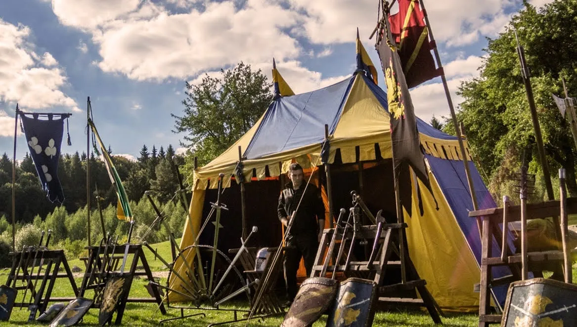 Blue and yellow medieval tent in an event camp